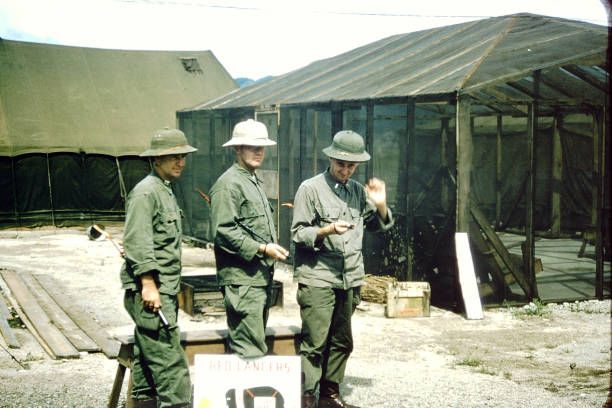 Portrait of, from left, American military surgeons Reynard Edrington, John 'Mumsworthy' Holden, and Roger Wilcox , each with a riding crop under...